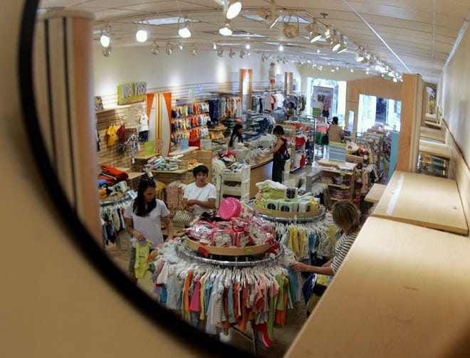 FILE- In this July 9, 2005, file photo a security mirror shows shoppers at a Gymboree store at Stanford Shopping Center in Palo Alto, Calif. ChildrenþÄôs clothing retailer Gymboree has filed bankruptcy protection for a second time in as many years and will begin winding down all operations. The San Francisco company said late Wednesday, Jan. 17, 2019, that it will close all of its Gymboree and Crazy 8 stores, and will to sell its Janie and Jack business, intellectual property and online business. (AP Photo/Paul Sakuma, File)