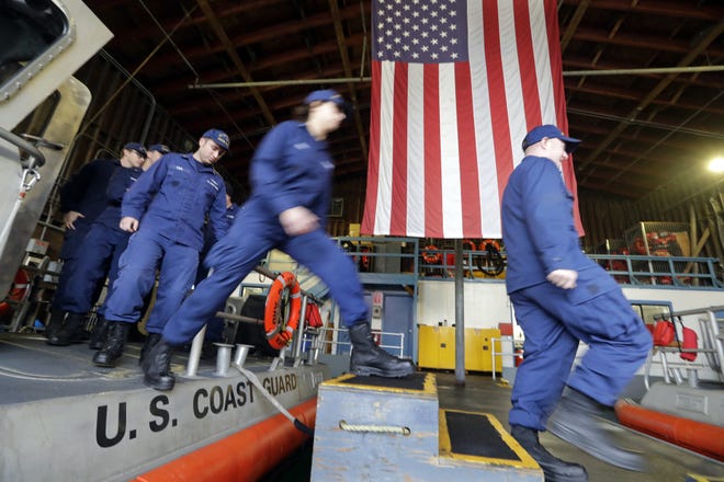 U.S. Coast Guardsmen and women, who missed their first paycheck a day earlier during the partial government shutdown, walk off a 45-foot response boat during their shift Wednesday at Sector Puget Sound base in Seattle. San Antonio-based USAA, a military personnel insurer and financial services company, said Wednesday they donated $15 million for interest-free loans to Coast Guard members during the partial U.S. government shutdown. The funds will be disbursed by Coast Guard Mutual Assistance. The American Red Cross Hero Care Center will assist. [AP File Photo/Elaine Thompson]