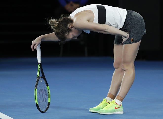 Romania's Simona Halep rests on her racket after losing a point to the United States' Sofia Kenin during their second-round match at the Australian Open in Melbourne on Thursday. [AARON FAMILA/THE ASSOCIATED PRESS]