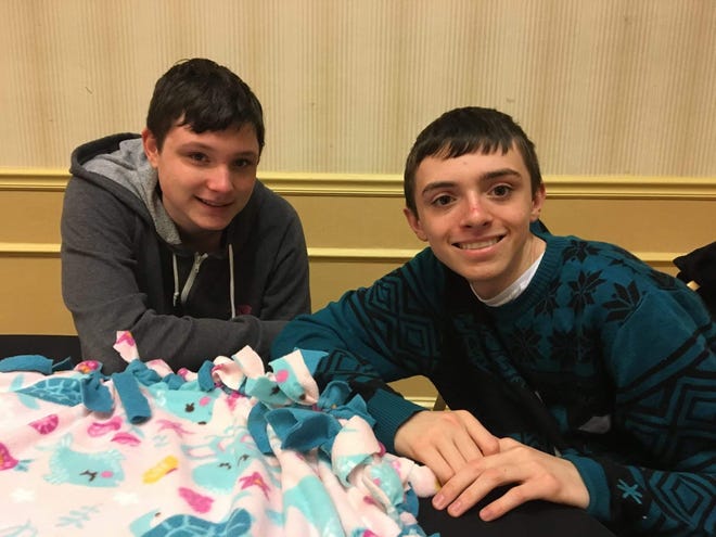 Reality panelist Brendan Collins, left, and his brother Danny volunteer at a Martin Luther King Jr. Day of Service event for Cozies4Chemo, a nonprofit that provides hand-tied blankets to chemotherapy patients. [COURTESY BRENDAN COLLINS]