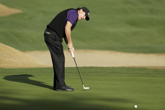 Phil Mickelson watches his putt on the 10th hole during the second round of the Desert Classic golf tournament on the Nicklaus Tournament Course at PGA West on Friday in La Quinta, Calif. [AP Photo/Chris Carlson]