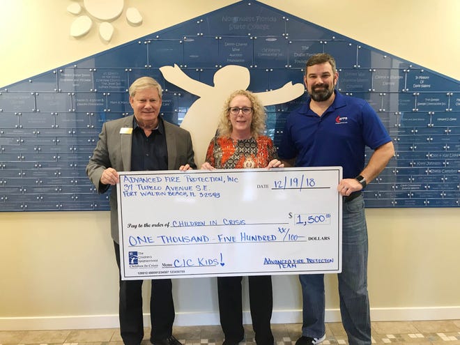 At check presentation is (from left) Ken Hair, Children In Crisis president and CEO, and Jackie Kirly and Michael Sudheimer representing Advanced Fire Protection Services. [CONTRIBUTED PHOTO]