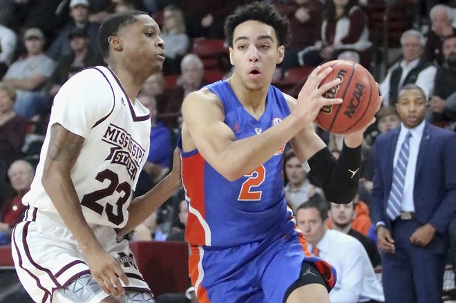 Florida guard Andrew Nembhard drives around Mississippi State guard Tyson Carter in the second half Tuesday in Starkville, Miss. [Jim Lytle/Associated Press]