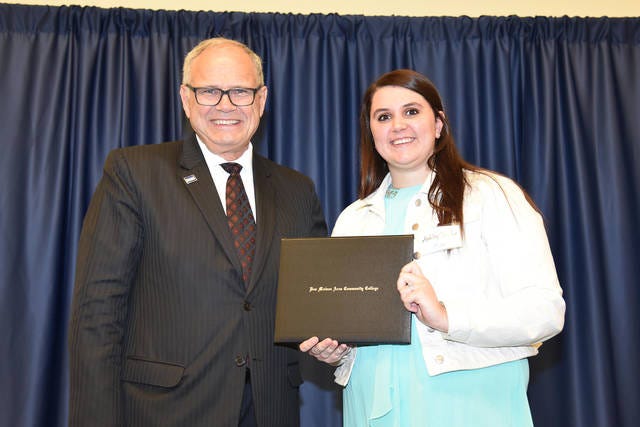 DMACC Ankeny Campus student Ashley Taylor, right, of Boone, receives congratulations from DMACC Executive Vice President of College Operations Dr. Stan Jensen.