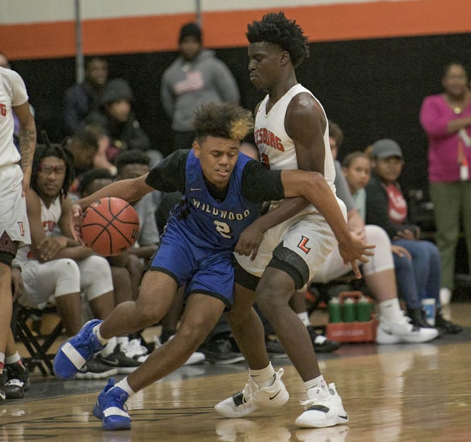 Wildwood's Marcus Niblack (2) drives past Leesburg's Lance Erving (2) during a game on Nov. 27, 2018, in Leesburg. Niblack, a junior, is averaging 23.3 points per game this year. [PAUL RYAN / CORRESPONDENT]