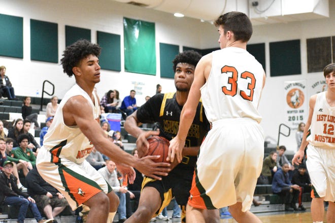 East Lincoln's Sidney Dollar (left) and Petey Nichols get a hand on the ball as Kings Mountain's Zeke Littlejohn prepares to rise for a shot during Saturday's game. [JOE L. HUGHES II/Gaston Gazette]
