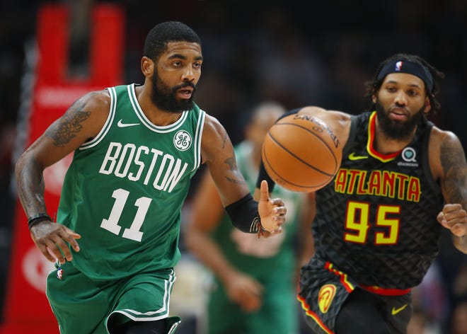 Celtics guard Kyrie Irving (left) brings the ball up as Atlanta Hawks forward DeAndre' Bembry defends during the first half of Boston's win in Atlanta on Saturday. [AP Photo/Todd Kirkland]