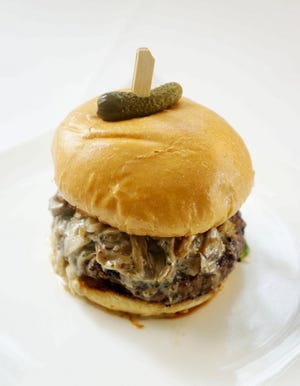 Bomb Burger, served on a toasted potato roll, is made up of lemon curd-and-caper aioli, house-made bread and butter pickles, and fresh grated Parmesan plus garlic-and-rosemary creamed wild mushrooms, foie gras and Maldon sea salt. [Photos courtesy of Palm Beach Food & Wine Festival]