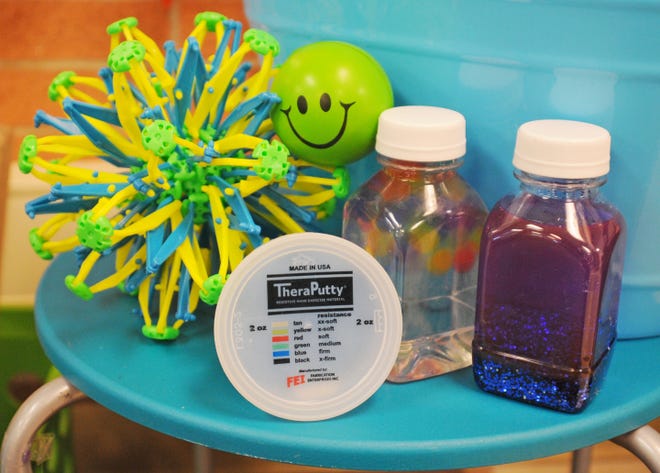 Students at Salina's Heusner Elementary School can play with therapy putty, a stress ball, sensory bottles or a Hoberman sphere in the peace zone, a designated area in each classroom where students can go to release stress. [Aaron Anders / Salina Journal]