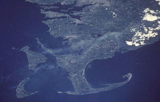 This is a June 1998 NASA handout photo showing Cape Cod, the island of Martha's Vineyard, left, and the island of Nantucket, left-bottom, in a view from space. U.S. Census figures for Massachusetts released in 2001 showed that growth on Cape Cod and the two islands outpaced areas in the rest of the state, and Nantucket was the fastest growing county. When the 2020 Census is conducted next year, Cape Cod communities are expected to be among the Massachusetts towns that have lost the largest percentage of population. [ NASA/AP FILE PHOTO ]