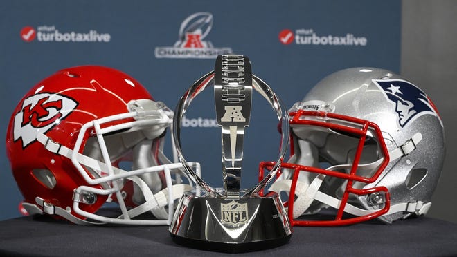 The Lamar Hunt Trophy stands between helmets of the Kansas City Chiefs and the New England Patriots, during a news conference Wednesday in Kansas City, Mo. The Chiefs play the Patriots for the AFC championship Sunday. [John Sleezer/The Kansas City Star via AP]