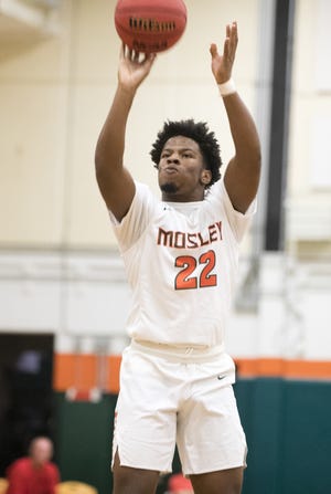 Mosley's Emmanuel Holmes puts up a jump shot during Friday's 76-60 Dolphins victory over Bay. [JOSHUA BOUCHER/THE NEWS HERALD]