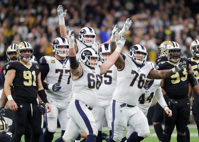 Los Angeles Rams players celebrate Greg Zuerlein's game-winning 57-yard field goal in overtime. (Associated Press/Gerald Herbert)