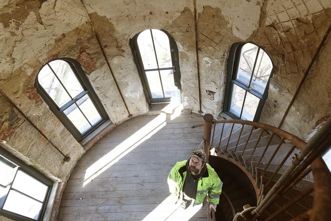 Water department mechanic Moe Millerick is seen on the landing below the peak level of the water tower, seen Tuesday, January 15, 2019, in Fall River, Massachusetts. [Herald News Photo | Jack Foley]