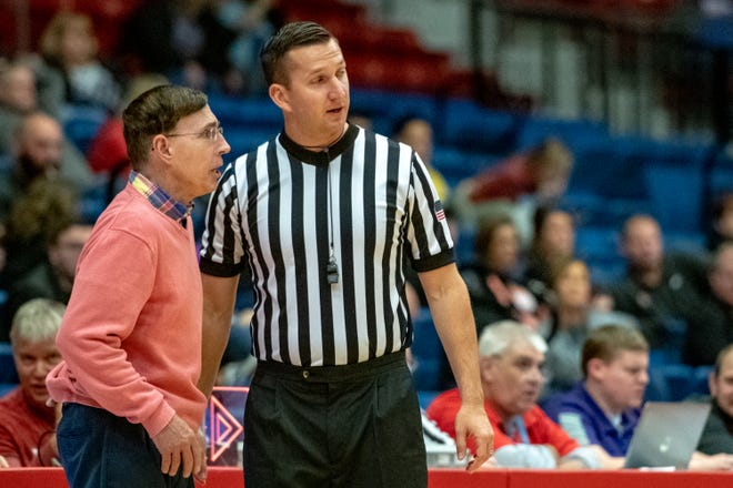 Buhler athletic director Justin Seuser speaks with Hutchinson Head Coach Steve Eck on the sidelines as Seuser referees Hutchinson's game against Cowley, Saturday, Jan. 12, 2019. [Jesse Brothers/HutchNews]