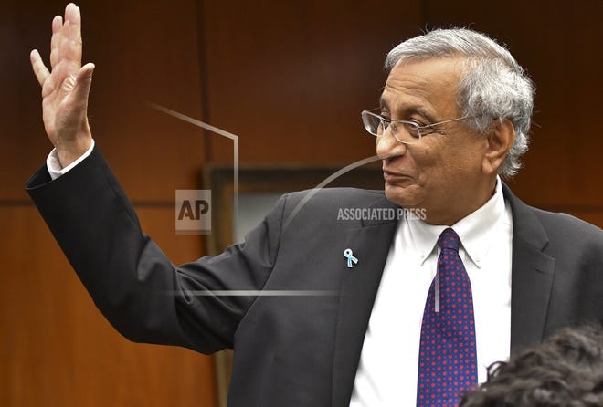 Satish Udpa waves after being named interim president of Michigan State University, Thursday morning, Jan. 17, 2019, during a Board of Trustees meeting at the Hannah Administration Building at MSU in Lansing, Mich. The board acted Thursday, a day after John Engler said he'd step down next week . Engler's resignation comes amid fallout from remarks he made about some victims of former sports doctor and convicted sexual abuser Larry Nassar. (Matthew Dae Smith/Lansing State Journal via AP)