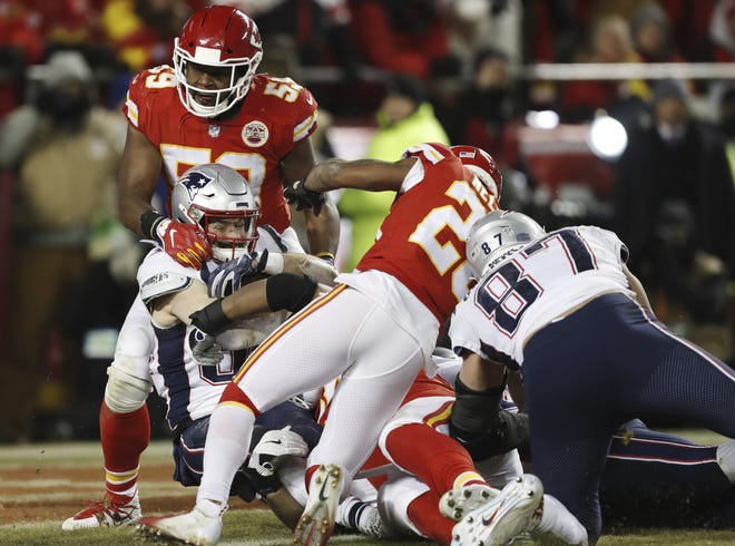 New England Patriots running back Rex Burkhead (34) dives to the end zone for a touchdown during overtime of the AFC Championship game against the Kansas City Chiefs on Sunday in Kansas City, Mo. The Patriots won 37-31. [The Associated Press / Jeff Roberson]