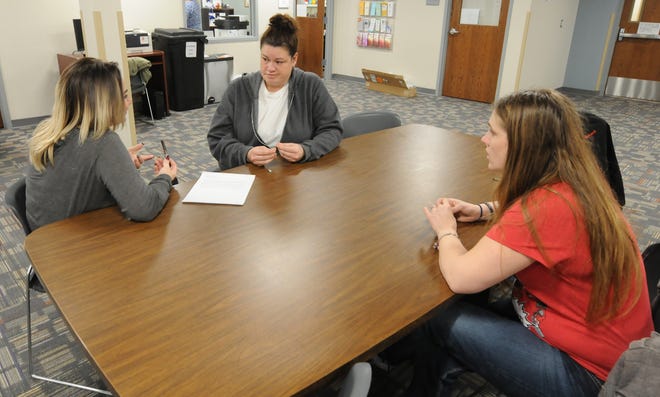 Kylie Sotelo, addiction recovery coach, meets with Shaina Laskowski and Theresa Henderson in the CKF Addiction Treatment building in Salina. [AARON ANDERS/SALINA JOURNAL]