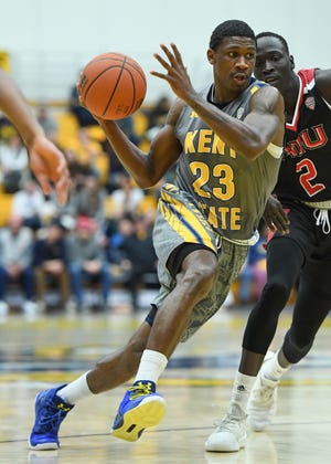Kent State's Jaylin Walker drives to the basket against Northern Illinois' Gairges Daow on Saturday at the M.A.C. Center. Walker had 31 points and eight rebounds in the 78-68 victory. [NICK CAMMETT/RECORD-COURIER]