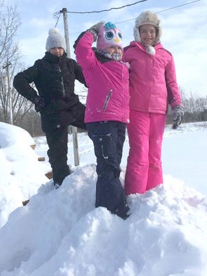Julie Linder submitted this photo of, from left, Emma Linder, Isabella Linder and Clair Brightbill, having fun in the snow after the weekend snowstorm came through the Ashland area.