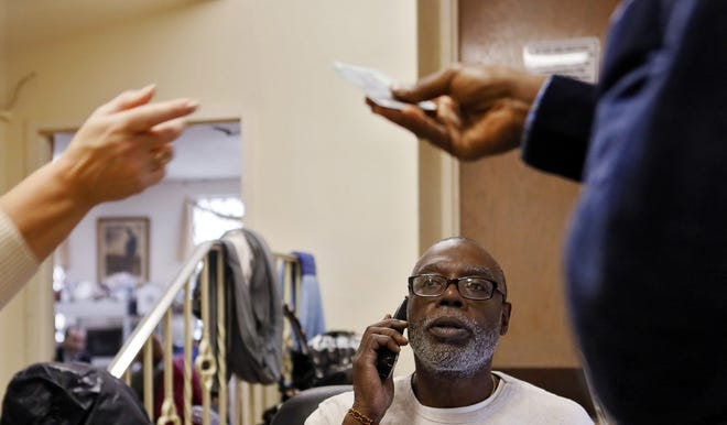 Solomon Dean, a deputy director at The Open Shelter, tries to help clients navigate the state's new computer system for receiving food stamps. [Eric Albrecht/Dispatch]