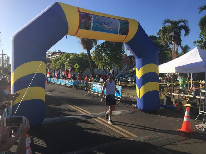 Warren resident and Edinboro University professor Jim Roberts crosses the finish line Sunday at the Maui Oceanfront Marathon as he completes a marathon in his 50th state, Hawaii. [CONTRIBUTED PHOTO]
