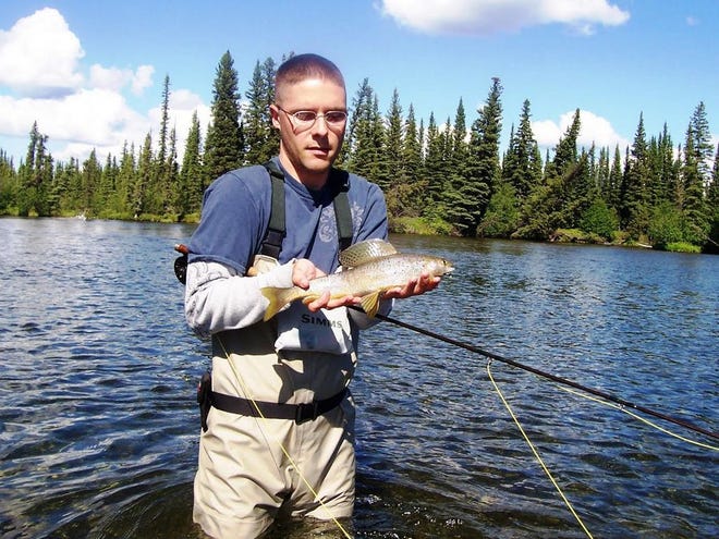 Cory Watts with an Arctic Grayling he caught on a fly fishing trip to Clearwater Creek near Delta Junction.