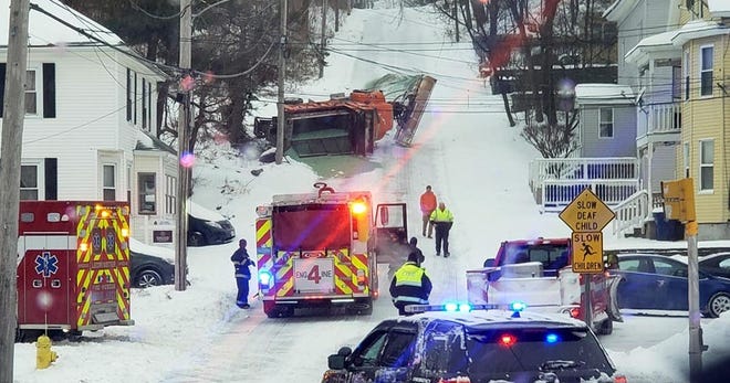 Crews respond to the scene of a snow plow that slid down High Street in Leominster Sunday morning and flipped over, spreading salt all over the roadway. [SUBMITTED PHOTO]