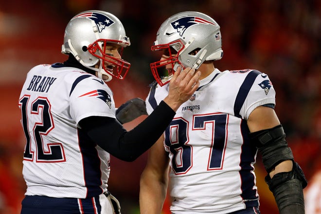 Tom Brady celebrates with tight end Rob Gronkowski during the second half of the AFC Championship Game against the Chiefs on Sunday in Kansas City. Each played a prominent role in the New England victory.