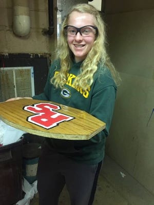 Ellie Erickson shows the miniature backboard she created and learned new skill sets on pertaining to woodworking.