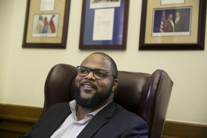 State Rep. Eric Johnson, D-Dallas, smiles in his office at the Capitol moments after the State Preservation Board voted to remove from the Capitol in Children of the Confederacy Creed on Friday January 11, 2019.  [JAY JANNER/AMERICAN-STATESMAN]