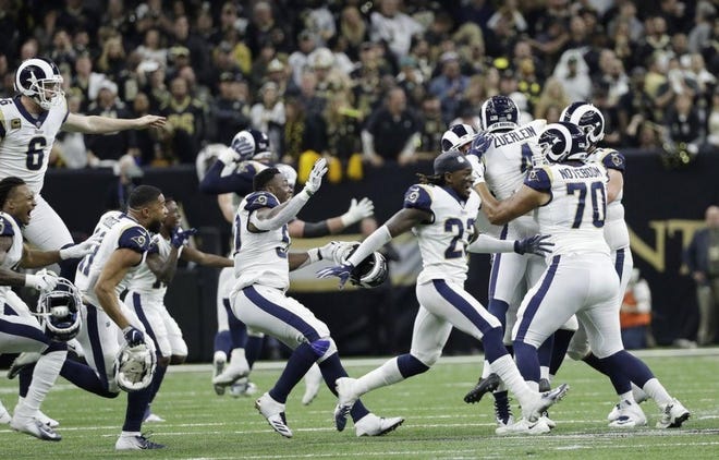 The Los Angeles Rams celebrate after an overtime win against the New Orleans Saints. [THE ASSOCIATED PRESS]