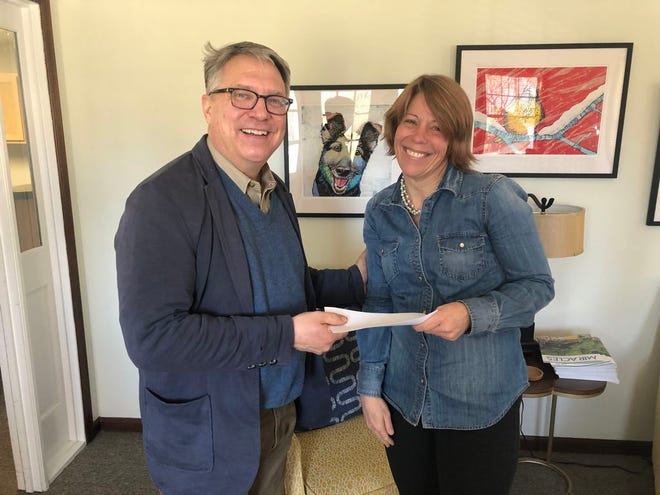 The Rev. Mark Rawls, senior pastor of First United Methodist Church, presents a $5,000 grant to Tanya Blackford, Crossnore’s regional director.