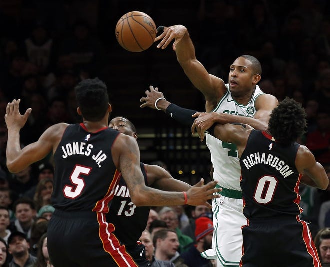 Celtics center Al Horford, getting off a pass despite the defensive pressure of the Heat's Josh Richardson and Derrick Jones Jr. on Monday, will get a night off when Boston hosts the Cavaliers on Wednesday. [Winslow Townson/AP]