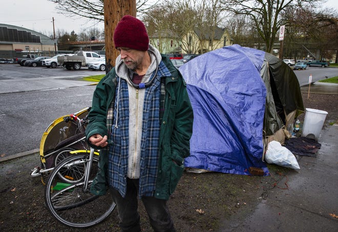 Neal Petersen contemplates his next move after receiving notice from the City of Eugene that he and his girlfriend will have to move their camp from its Fourth Avenue location in Eugene by Wednesday morning. [Chris Pietsch/The Register-Gaurd] - registerguard.com