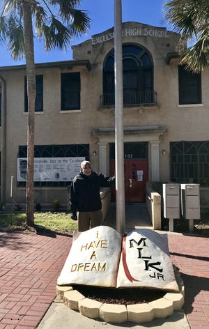 Floyd Phillips, president of the Lincolnville Museum and Cultural Center, stands in front of the museum with the new artwork donated by artist William J. Richards. [Stevie Lynne/Contributed]
