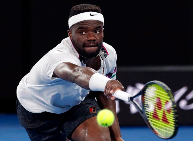 United States' Frances Tiafoe reaches for a return to Spain's Rafael Nadal during their quarterfinal match at the Australian Open tennis championships in Melbourne, Australia, Tuesday, Jan. 22, 2019. (AP Photo/Aaron Favila)