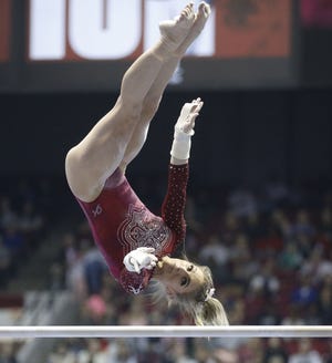Lexi Graber competes on the bars in Coleman Coliseum Friday, Jan. 11, 2019. [Staff Photo/Gary Cosby Jr.]
