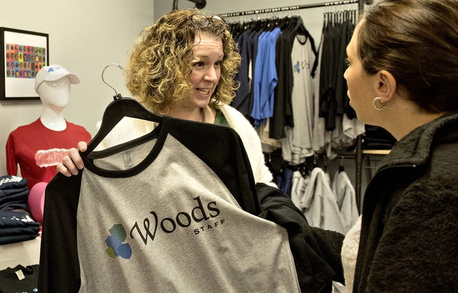 Woods Services employees Jodie Kamara, left, and Sarra Nessinger shop at Woods Wear in Middletown on Wednesday. The new custom apparel business is located at the residential facility for people with developmental disabilities and sells custom designed clothing by Wood Services residents and staff. [KIM WEIMER / STAFF PHOTOJOURNALIST]