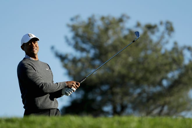 Tiger Woods watches his tee shot on the eighth hole during the pro-am round of the Farmer's Insurance Open golf tournament on the North Course at Torrey Pines Golf Course on Wednesday, Jan. 23, 2019, in San Diego, Calif. (AP Photo/Chris Carlson)