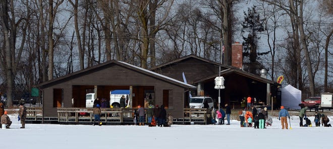 Ice fishing at Waterworks Ponds is a traditional activity during the annual Presque Isle Snow Day. [GREG WOHLFORD/ERIE TIMES-NEWS]