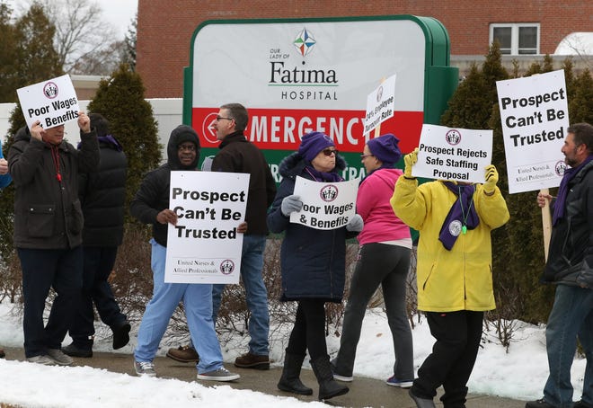 Members of the United Nurses and Allied Professionals Local 5110 hold an informational picket outside Our Lady of Fatima Hospital on Wednesday protesting owner Prospect CharterCARE's record on patient and worker safety. [The Providence Journal / Bob Breidenbach]