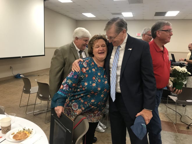 Outgoing executive director for Cleveland County Partnership for Children Cathy Taylor hugs state Senator Ted Alexander after receiving the Order of the Long Leaf Pine. [Joyce Orlando/The Star]