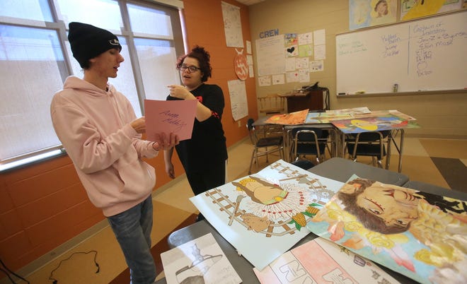 From left, Aaron Mathey, 17, and Sam Wallace, 18, look over projects from the past at Cleveland Early College High School. [Brittany Randolph/The Star]