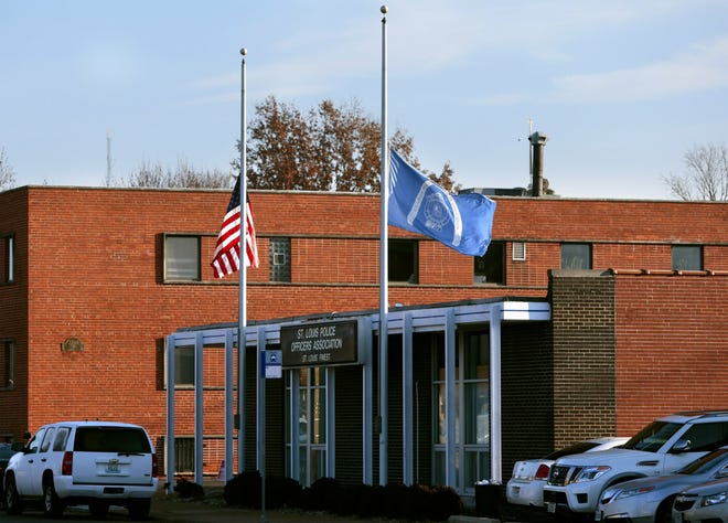 Flags fly at half-staff in front of the St. Louis Police Officers Association on Thursday, Jan. 24, 2019, following the shooting death of a police officer. Authorities say a St. Louis police officer has accidentally shot and killed another officer. [Robert Cohen/St. Louis Post-Dispatch via AP]