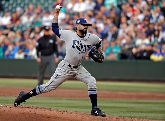 FILE - In this June 1, 2018, file photo, Tampa Bay Rays starting pitcher Sergio Romo throws to a Seattle Mariners batter during the first inning of a baseball game in Seattle. A person familiar with the negotiations tells The Associated Press that Major League Baseball has proposed going back to a 15-day disabled list and increasing the time optioned players usually must spend in the minor leagues. The moves are aimed at reducing the use of relief pitchers and reviving offense. (AP Photo/Ted S. Warren, File)