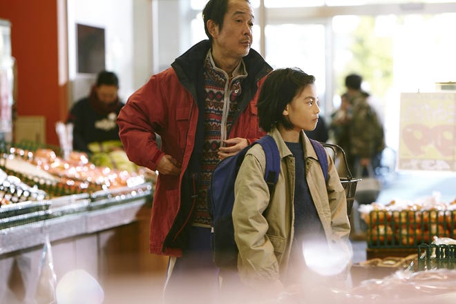 Father, Osamu Shibata (Lily Franky) and son Shota (Jyo Kairi) work together to snag merchandise from stores in "Shoplifters." [Magnolia Pictures]