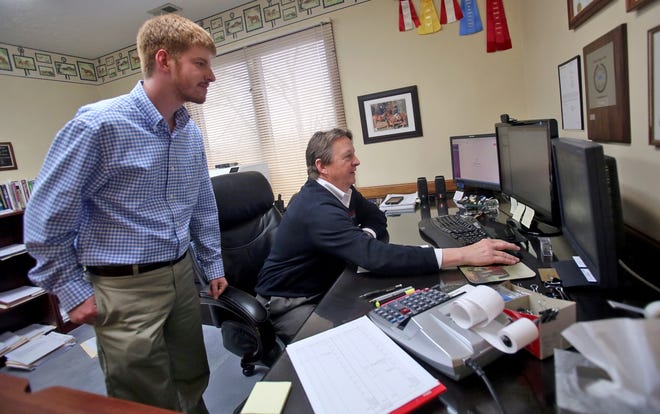 From left, Jeremy Putnam and Travis Mangum work on taxes at Mangum & Associates Inc. in Shelby on Wednesday. [Brittany Randolph/The Star]
