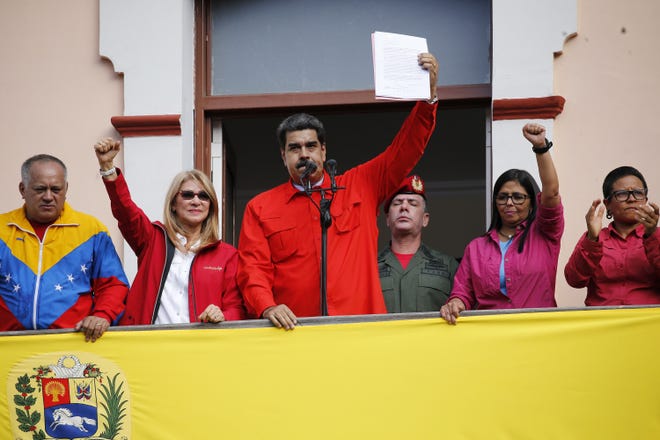 Venezuelan President Nicolas Maduro announces he is breaking relations with the U.S. to supporters from a balcony at Miraflores presidential palace in Caracas, Venezuela, Wednesday. [AP Photo/Ariana Cubillos]