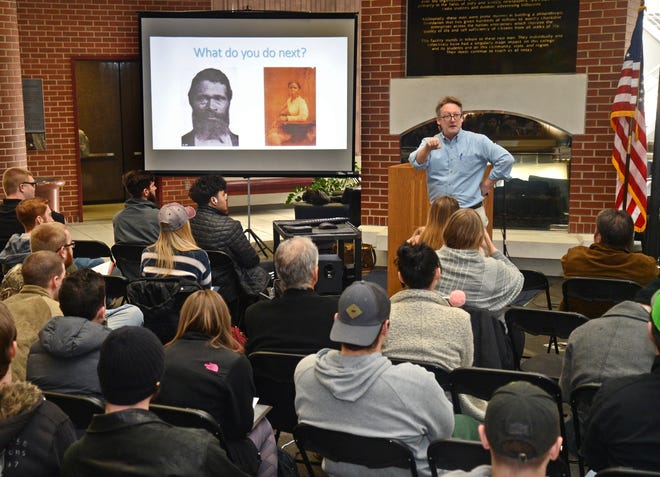 Mike Crane, associate professor of history at the University of Arkansas at Fort Smith gives a lecture titled "Love and Action During Reconstruction" on Wednesday, Jan. 23, 2019, at the fireplace in the Smith-Pendergraft Campus Center. Crane first asked students attending, "If you were a slave who just received your freedom, what would you do next?" The lecture was part of the university's educational events in January to celebrate Martin Luther King Jr. [BRIAN D. SANDERFORD/TIMES RECORD]